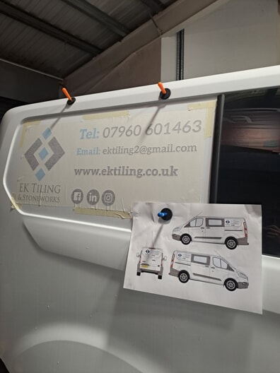 An image of the van with a paper on it that shows plans for the intended graphics updates